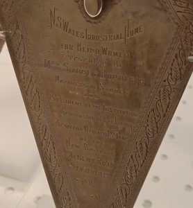 Ceremonial silver trowel made by Hardy Brothers on display at State Library of NSW, 18 July 2024. Courtesy Strathfield Local Studies Silver-trowel-presented-to-Mrs-Burdekin-when-laying-memorial-stone-in-Strathfield-24-March-1891-on-display-at-SLNSW-18-July-2024-cropped-278x300.jpg